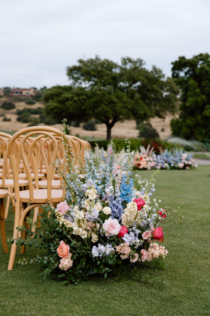 ceremony aisle florals with chairs at a Santaluz Club wedding in San Diego