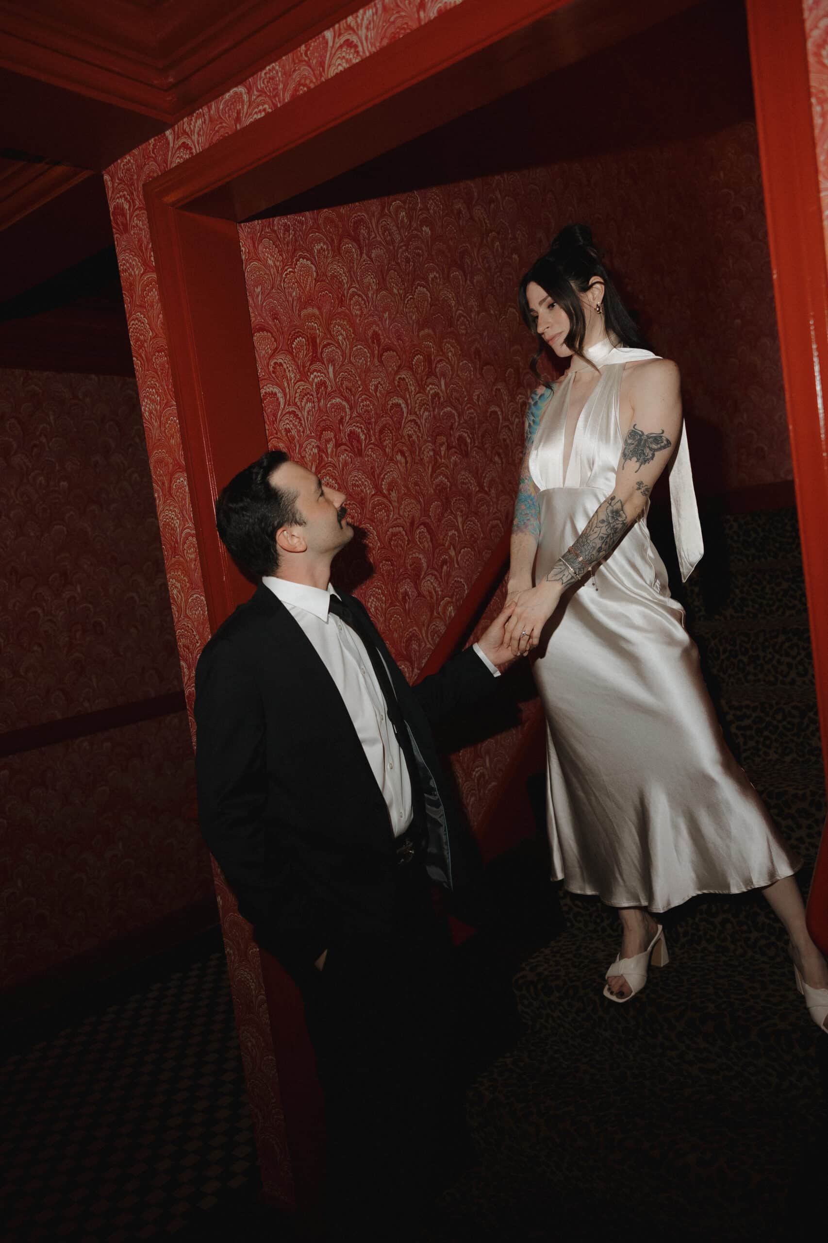 Couple posing for an editorial engagement photo at The Lafayette Hotel in San Diego, surrounded by the hotel’s stylish vintage architecture and colorful details