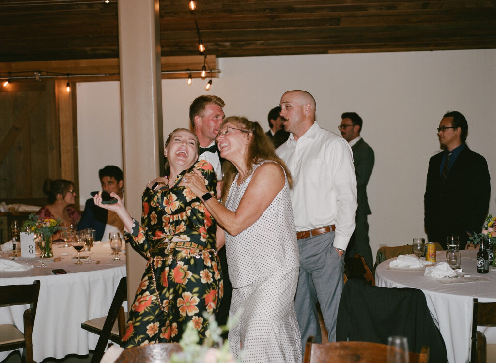 Wedding guests laughing and dancing together during the reception