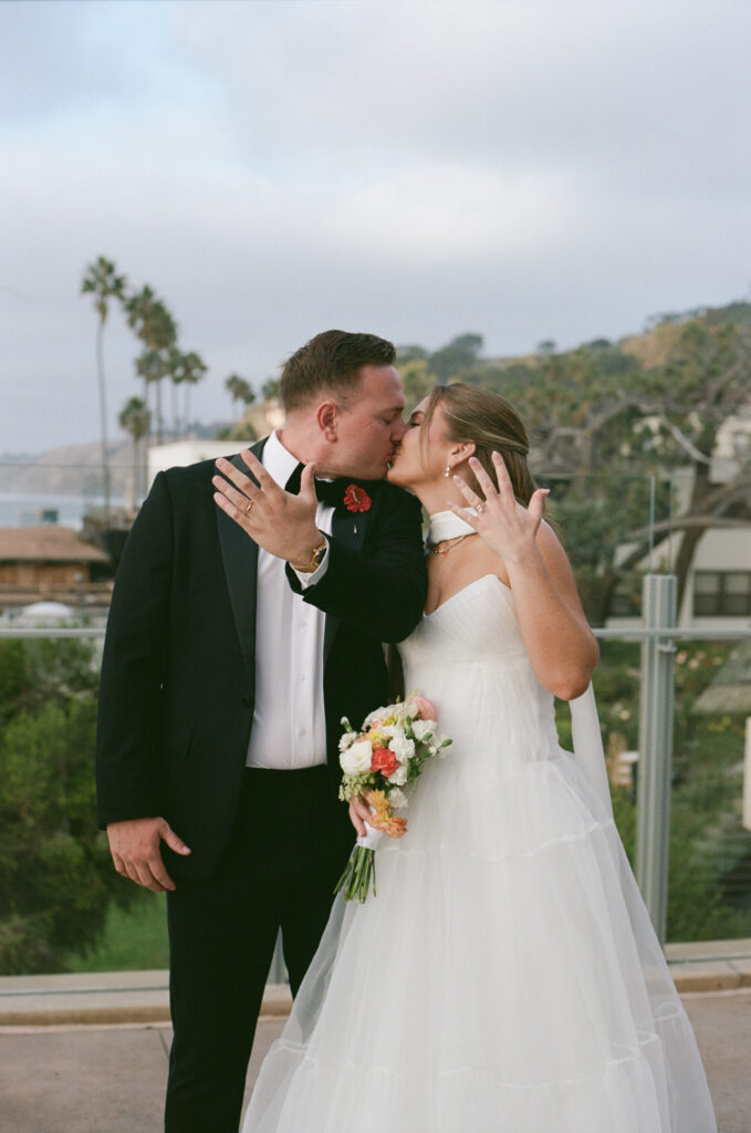 Film photograph of Ben and Lauren sharing a kiss after their wedding ceremony