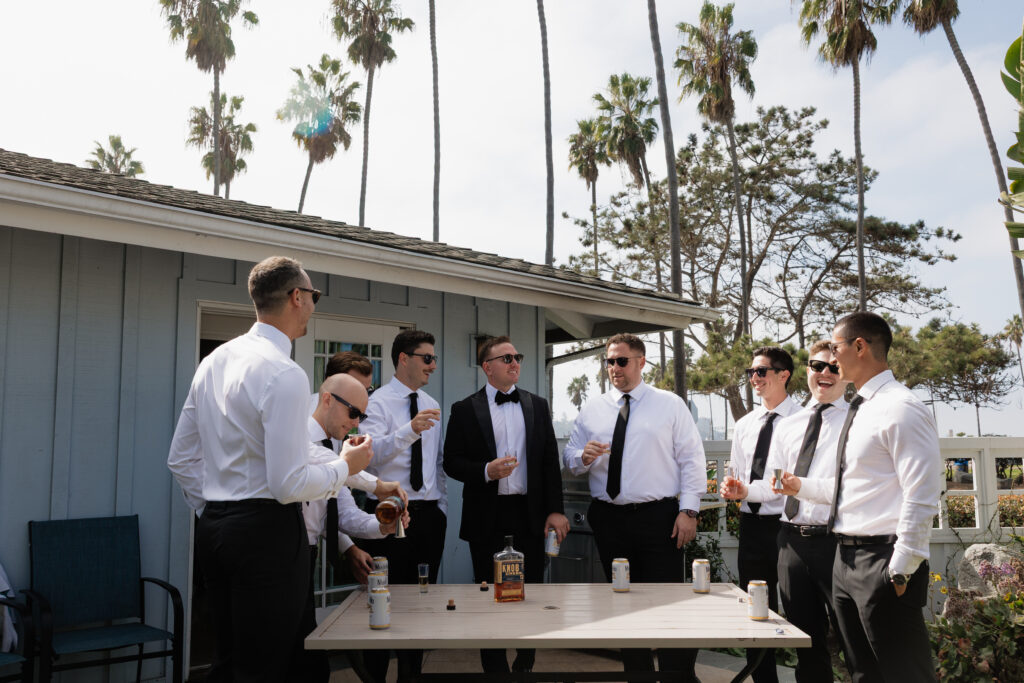 Groom and wedding party enjoying drinks before the La Jolla wedding ceremony