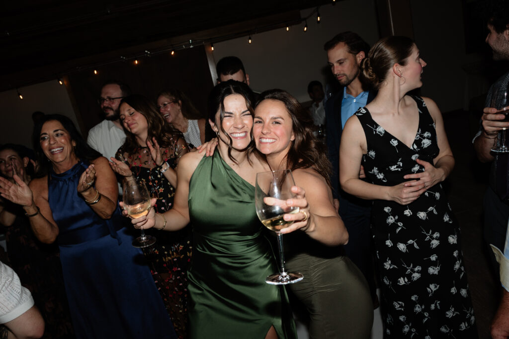 Wedding guests laughing and celebrating together during the reception