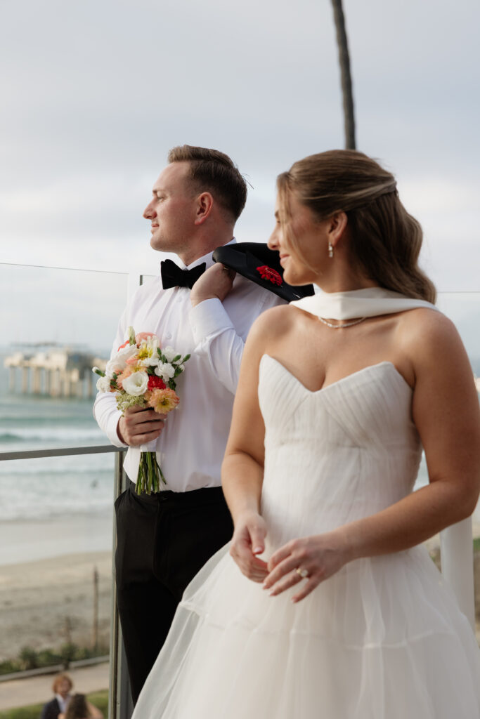 Newlyweds smiling together on the La Jolla coastline