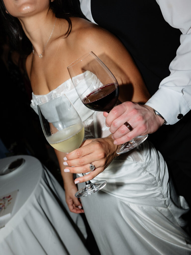 Bride and groom holding wine glasses during their Halter Ranch reception