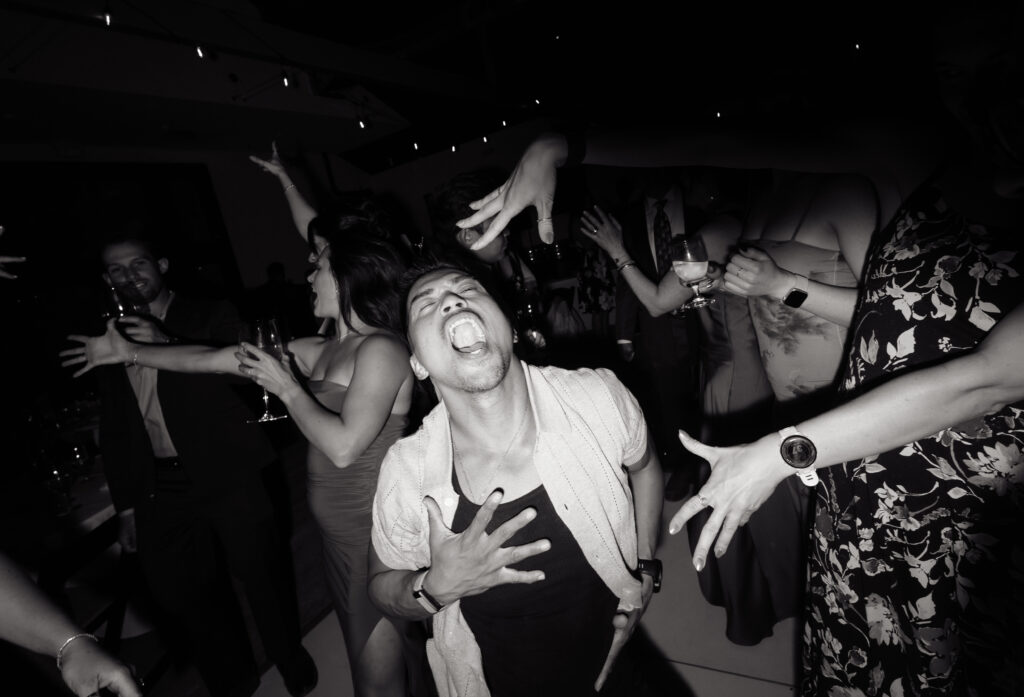 Guests laughing and dancing together during the lively Halter Ranch wedding reception