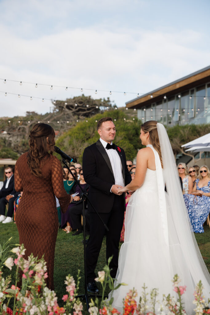 Ben and Lauren exchanging vows during their Scripps Seaside Forum wedding ceremony
