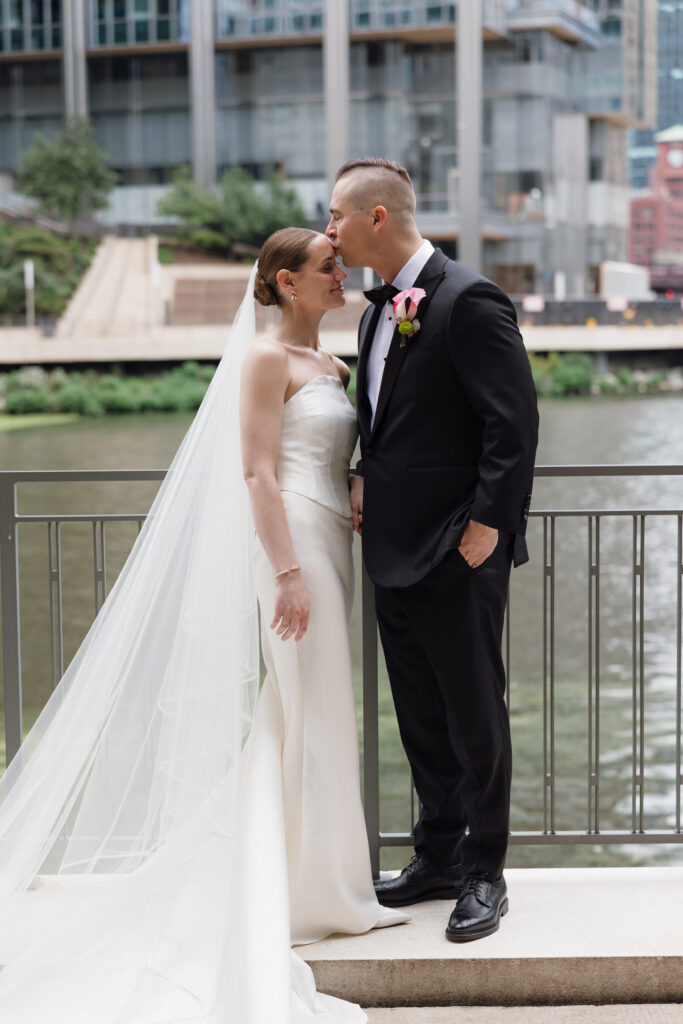 Marykate and Joe share a kiss overlooking the Chicago River during their Loft Lucia wedding