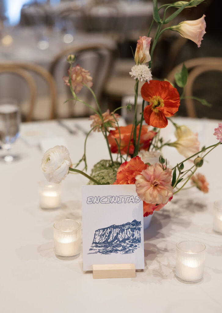 Colorful floral centerpiece and California-inspired table details at the wedding reception